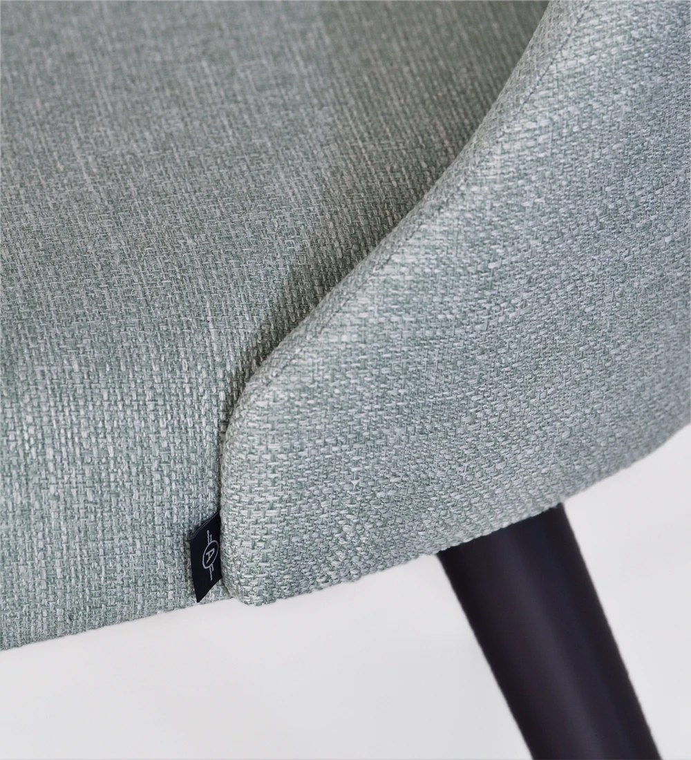 Chair upholstered in fabric, with black lacquered feet.