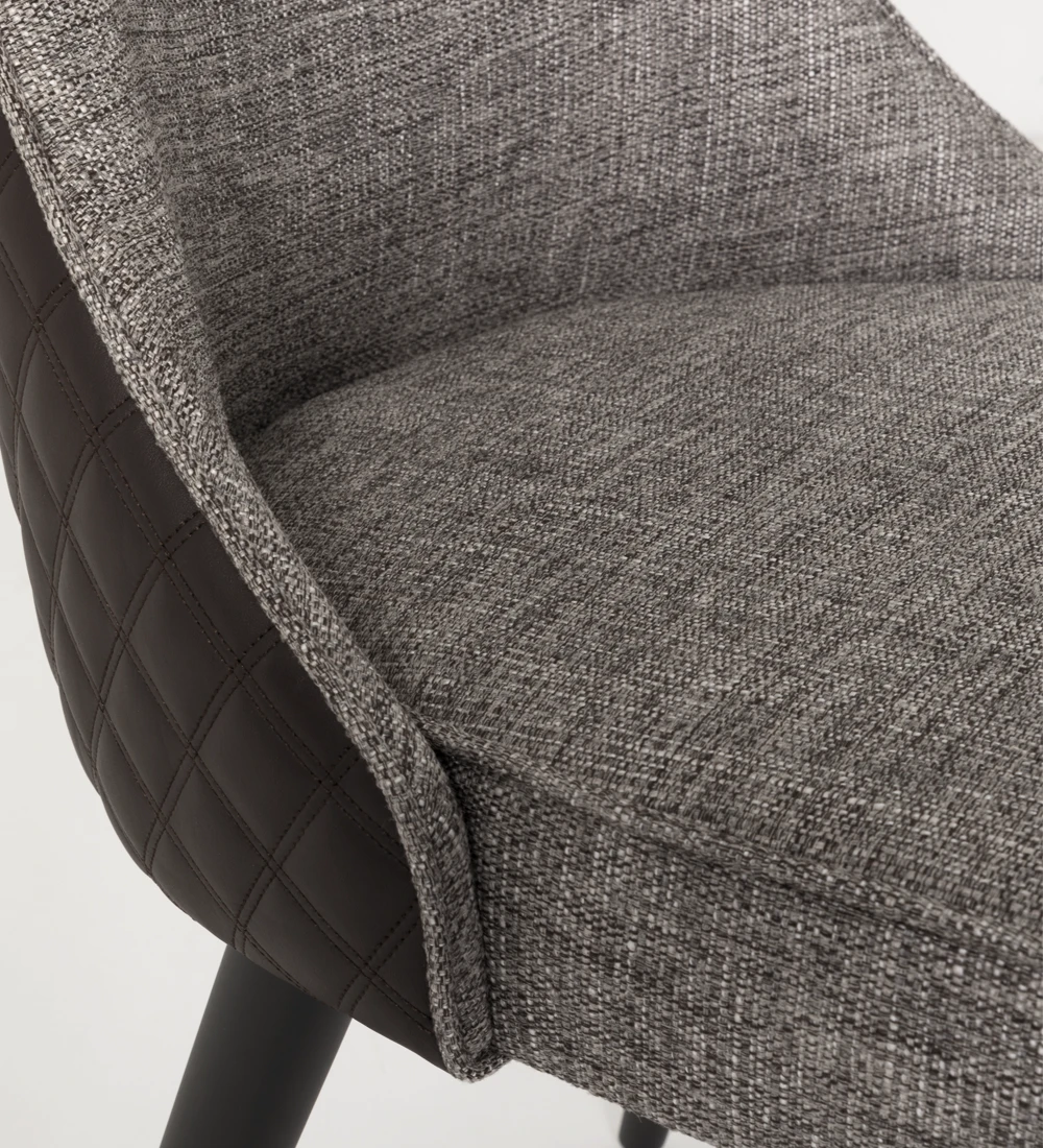 Fabric upholstered chair with black lacquered feet.