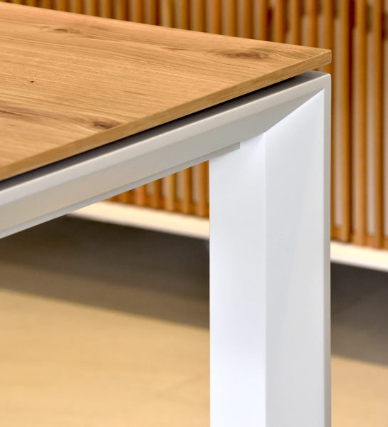 Rectangular extendable dining table with natural oak top, pearl lacquered metal legs.