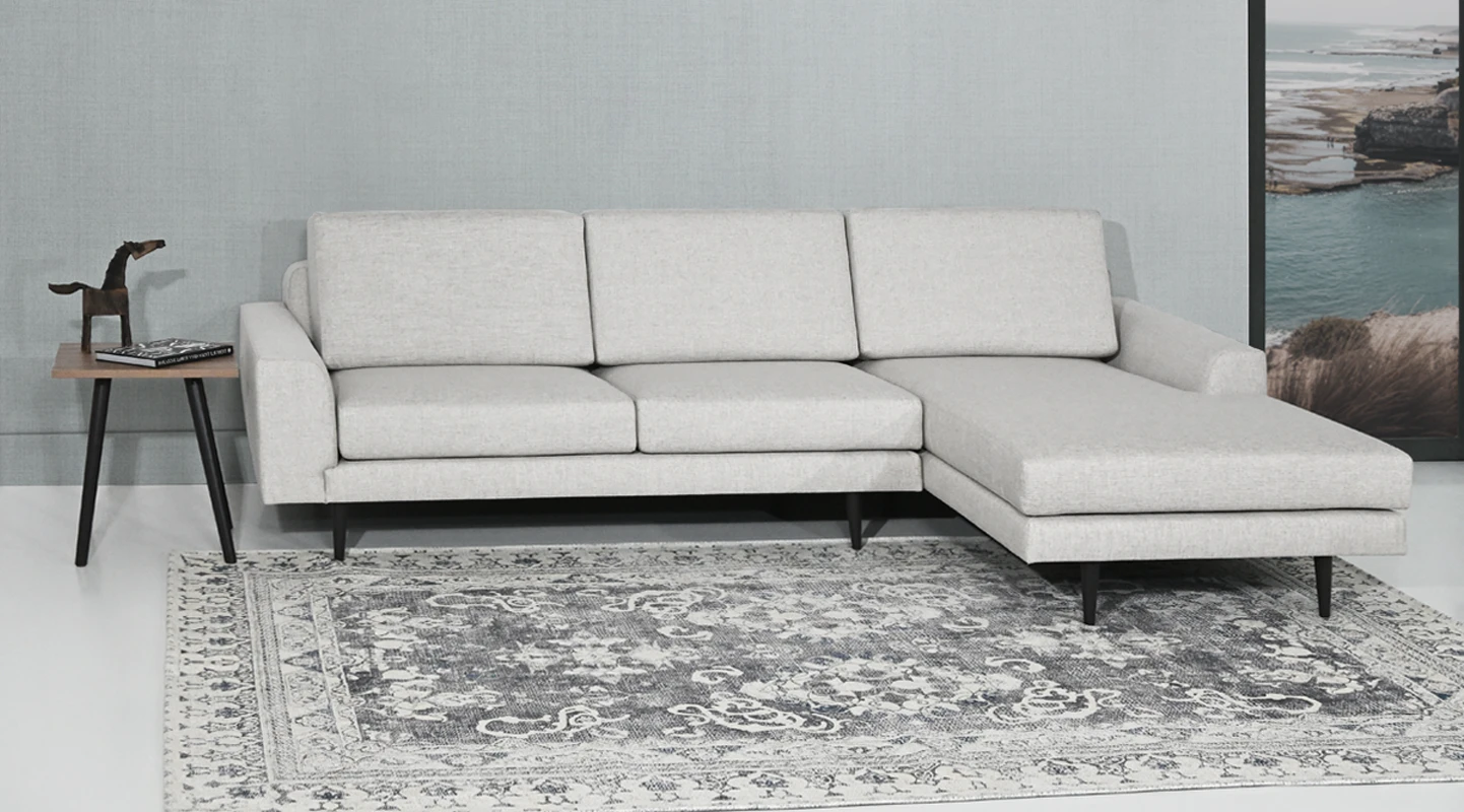 2 seater sofa with chaise longue, upholstered in fabric, with dark brown lacquered feet.