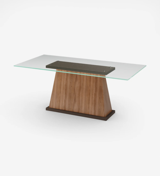 Table de repas rectangulaire avec plateau en verre, pied central en noyer et base laquée brun foncé.